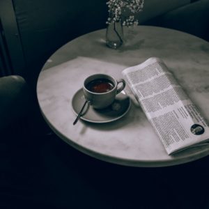 white ceramic tea cup on white ceramic saucer on round table